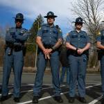 Troopers listen as Washington State Patrol Chief John Batiste addresses the media during a press conference regarding an overnight crash that killed trooper Chris Gadd on southbound I-5 Saturday, March 2, 2024, in Marysville, Washington. (Ryan Berry / The Herald)