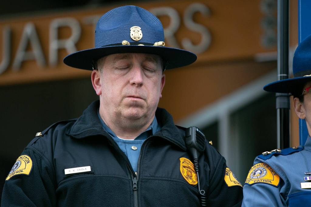 Washington State Patrol Lt. Christopher Caiola shuts his eyes while listening to Chief John Batiste address the media during a press conference regarding an overnight crash that killed trooper Chris Gadd on southbound I-5 Saturday, March 2, 2024, in Marysville, Washington. (Ryan Berry / The Herald)