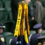The Washington State patrol flag bears the name of Trooper Chris Gadd at the end of a ceremony on Tuesday, March 12, 2024, at Angel of the Winds Arena in Everett, Washington. (Ryan Berry / The Herald)