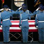 Members of Washington State patrol salute the casket of slain trooper Chris Gadd during a memorial cremony on Tuesday, March 12, 2024, at Angel of the Winds Arena in Everett, Washington. (Ryan Berry / The Herald)