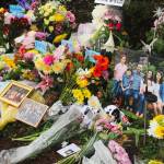 Flowers, framed photos, plush toys and a QR code to the GoFundMe pages of the families grace the memorial site after the March 19 crash. Photo by Bailey Jo Josie/Sound Publishing.