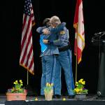 Captain Ron Mead and Corporal Alexis Robinson embrace during a memorial for Washington State Patrol trooper Chris Gadd on Tuesday, March 12 at Angel of the Winds Arena in Everett, Washington. (Ryan Berry / Sound Publishing)
