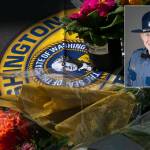 Flowers for slain trooper Chris Gadd begin to collect outside Washington State Patrol District 7 Headquarters on Saturday, March 2 in Marysville. (Ryan Berry / Sound Publishing)