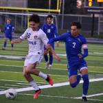 Kent-Meridian and Federal Way soccer players fight for possession earlier in the season. Ben Ray / The Reporter