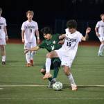 Ellis Nguyen and a Kentwood player fight to control the ball at Kentridge High School. Ben Ray / The Reporter
