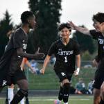 Manny Nzongani (left), Ethan Nonthaveth (middle) and Gabe Woodward (right) celebrate the first goal of the game. Ben Ray / The Reporter