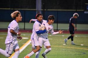 Johan Zuluaga gets some love from his teammates after scoring the game tying goal. Ben Ray / The Reporter