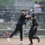 Head Coach Sydney Eacret and Sarah Wright high-five after her first homer of the day. Ben Ray / The Reporter