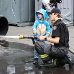 A child gets a chance to use a fire hose during Puget Sound Fires Teddy Bear Clinic on May 18. COURTESY PHOTO, Puget Sound Fire