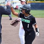Diya Thomas gives Coach Charlie Glenn a high-five against Emerald Ridge. Ben Ray / The Reporter
