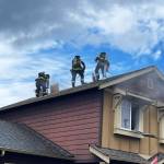 Puget Sound Fire firefighters take to the roof to combat a house fire Monday afternoon in Kent in the 23400 block of 134th Court SE. COURTESY PHOTO, Puget Sound Fire
