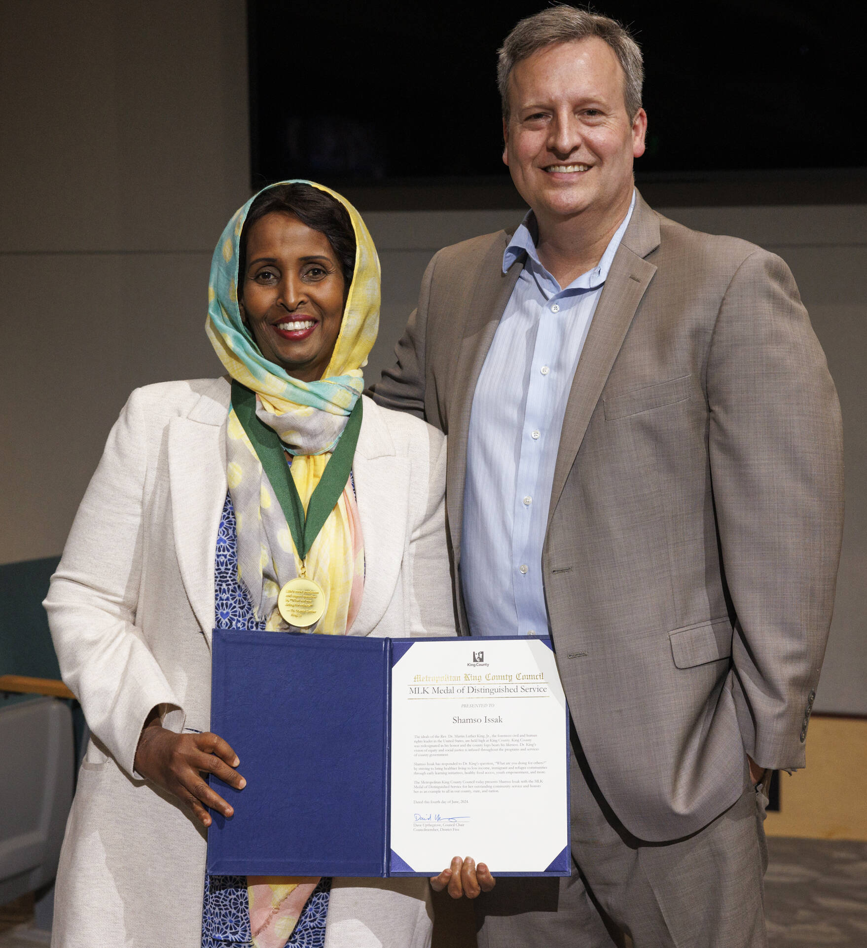 Shamso Issak, of Kent, receives King Countys Martin Luther King Jr. Distinguished Service Award from County Councilmember Dave Upthegrove June 4 at the Council chambers in Seattle. COURTESY PHOTO, King County
