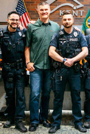 Washington State Patrol Trooper Raymond Seaburg, in the green shirt, at a recent event to honor the Kent Police officers who came to his aid. COURTESY PHOTO, Kent Police