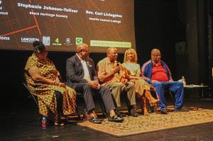 John Houston (center) speaks during a post-screening panel discussion for the King County Reparations Project. Pictured left to right: Stephanie Johnson-Tolliver, President of the Black Heritage Society of Washington State; Seattle Central College professor Rev. Carl Livingston; Houston; Director Angela Moorer; Former King County Councilmember Larry Gossett. Photo by Bailey Jo Josie/Sound Publishing