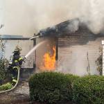 Firefighters battle a blaze Saturday, Aug. 3 at a house in the 24300 block of 138th Avenue SE. COURTESY PHOTO, Puget Sound Fire