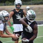 Kentwood RB Antoine Lee (right) and new quarterback Brandon Tagle (left) get some work in during practice at Kentwood. Ben Ray / The Reporter