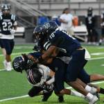 A gaggle of Titan defenders take down a Kentlake player. Ben Ray / The Reporter