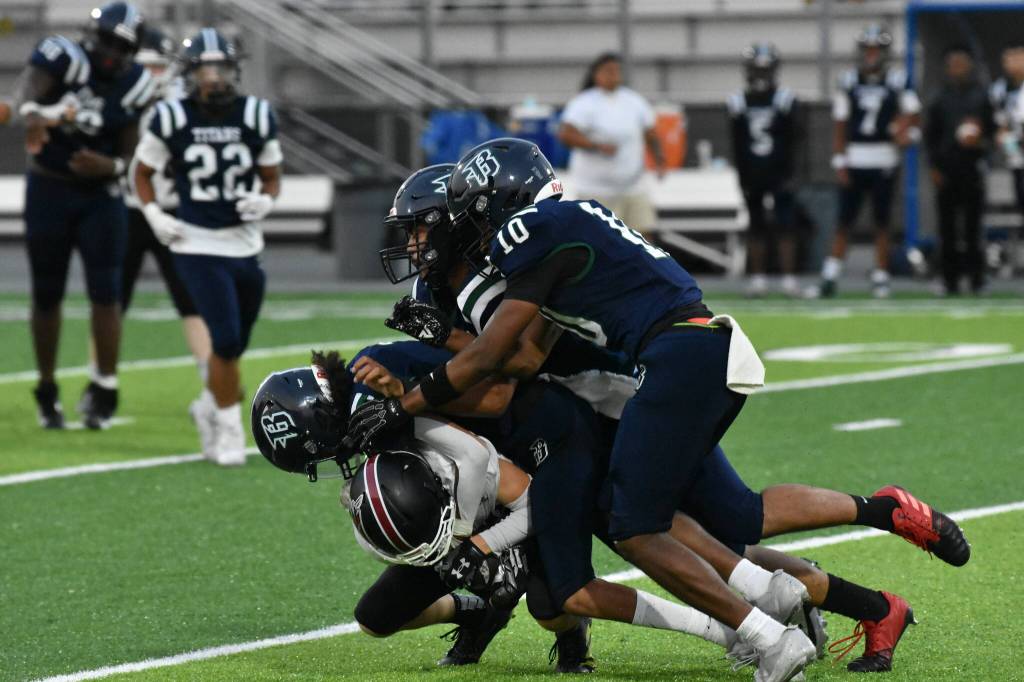 A gaggle of Titan defenders take down a Kentlake player. Ben Ray / The Reporter