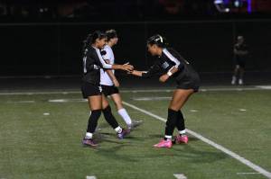 Kentwoods Diya Thomas and Alyssa Cromwell celebrate a goal with a handshake. Ben Ray / The Reporter
