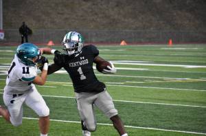 Kentwoods Antoine Lee stiff-arms a Raven defender. Ben Ray / The Reporter