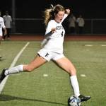 Kentwood junior defender Emma Campbell clears a ball in search of a teammate. Ben Ray / The Reporter