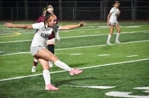 Lauren Tripp kicks the ball up-field for the Falcons. Ben Ray / The Reporter