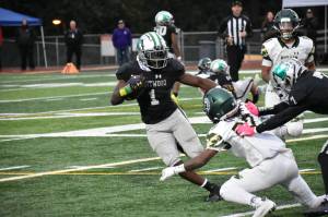 Senior running back Antoine Lee avoids a Trojan defender early in the game against Auburn. Ben Ray / The Reporter