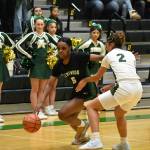 Kentwood senior Jessica Ajayi dribbles past an Auburn defender. Ben Ray / The Reporter