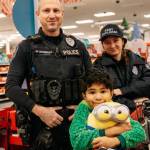 A Kent Police officer and explorer assist during the annual Shop with a Cop. COURTESY PHOTO, Kent Police