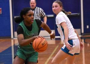 Kentwoods Jessica Ajayi dribbles the ball up the floor. Ben Ray / The Reporter