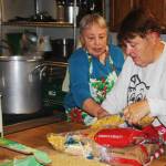 Nancy Turner, left, and Cathy Corrado, discuss preparations for the Dec. 16 Monday Night Supper. STEVE HUNTER, Kent Reporter