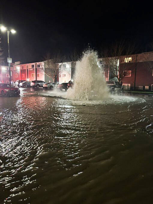 COURTESY PHOTO, Puget Sound Fire
Water flows out of a fire hydrant after being struck by a car Jan. 3 at the Appian Way Apartments on Kents West Hill.