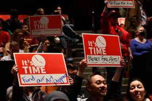 Attendees display their signs at the School Funding Crisis Eastside Town Hall on Jan. 8 at Sammamish High School in Bellevue. Andy Nystrom/ staff photo