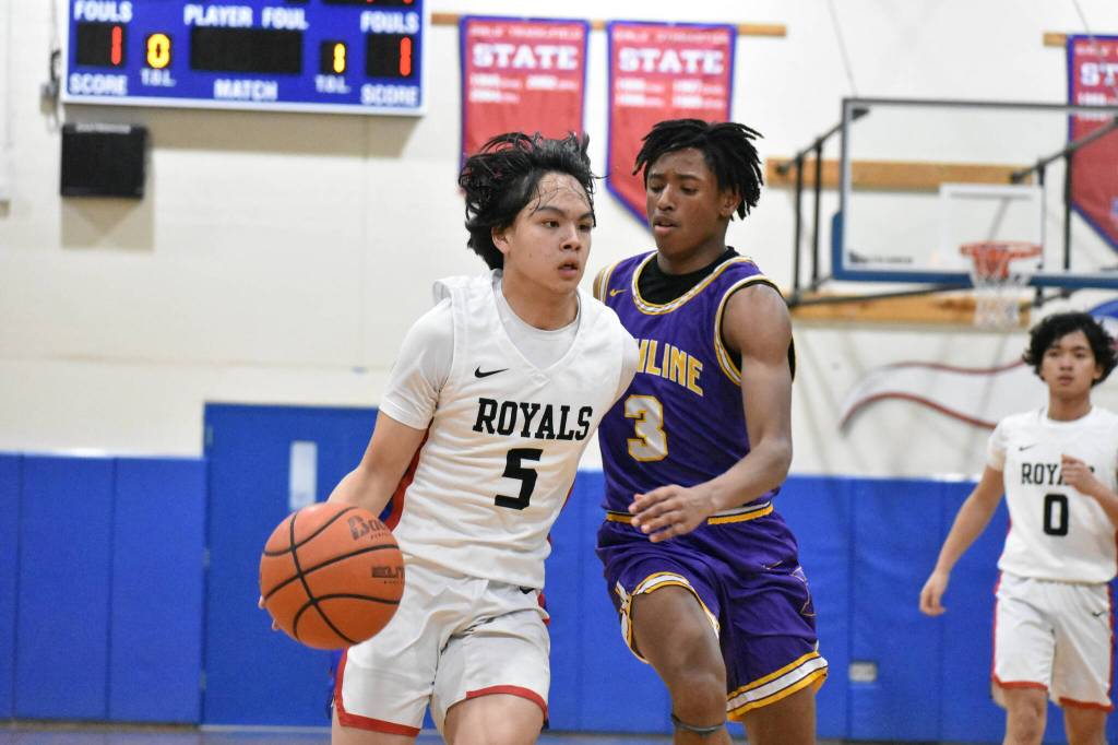 Sophomore Raymond Wong fights off a Highline defender for the Royals. Ben Ray / The Reporter