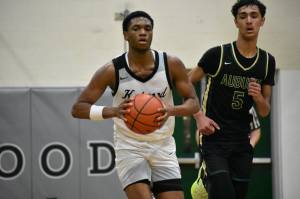 Corey Tita pushes the ball up the floor for Kentwood. Ben Ray / The Reporter