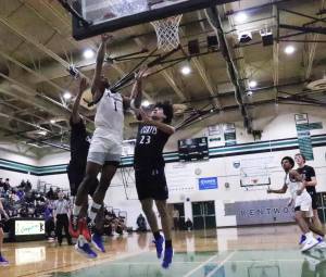 Corey Tita goes for a layup against Curtis. Tyler Rubenstein / For the Reporter