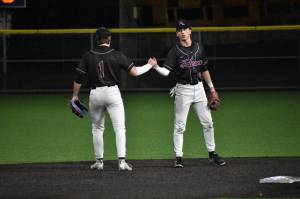 Christopher (left) and Lincoln Moore (right) shake hands on defense. Ben Ray / The Reporter
