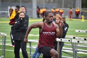 Kentlake sprinter takes first place in the first heat of the 100 meter dash. Ben Ray / The Reporter