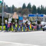 A line of marchers, with local Kelley Rush and her husband at the front, wait to cross the street in downtown Duvall during the Hands Off! event April 5, 2025. Photo courtesy of Travis Wetherbee/Last Lite Photography