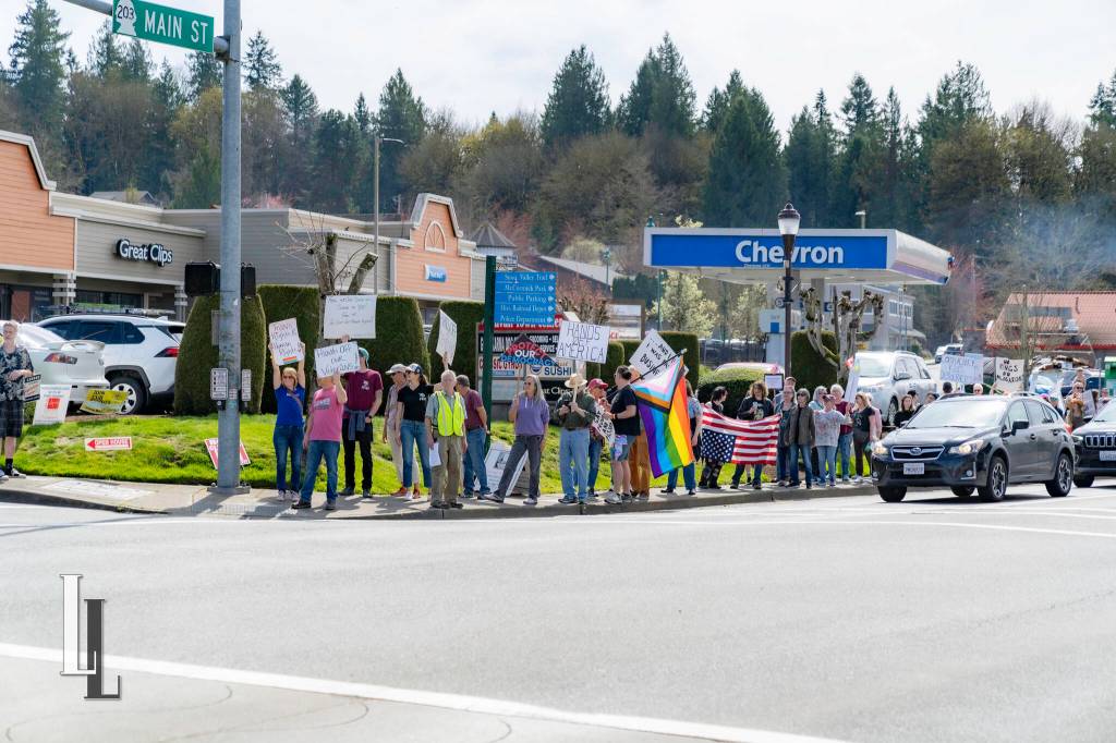 A line of marchers, with local Kelley Rush and her husband at the front, wait to cross the street in downtown Duvall during the Hands Off! event April 5, 2025. Photo courtesy of Travis Wetherbee/Last Lite Photography