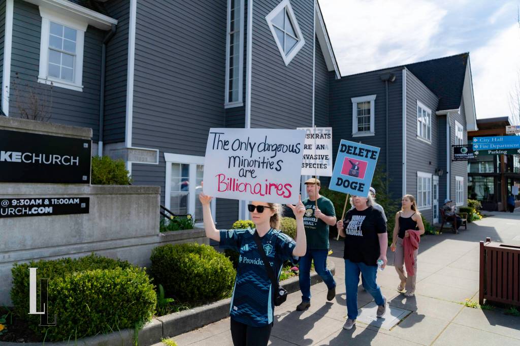 Marchers walk through downtown Duvall during the Hands Off! protest April 5, 2025. Photo courtesy of Travis Wetherbee/Last Lite Photography