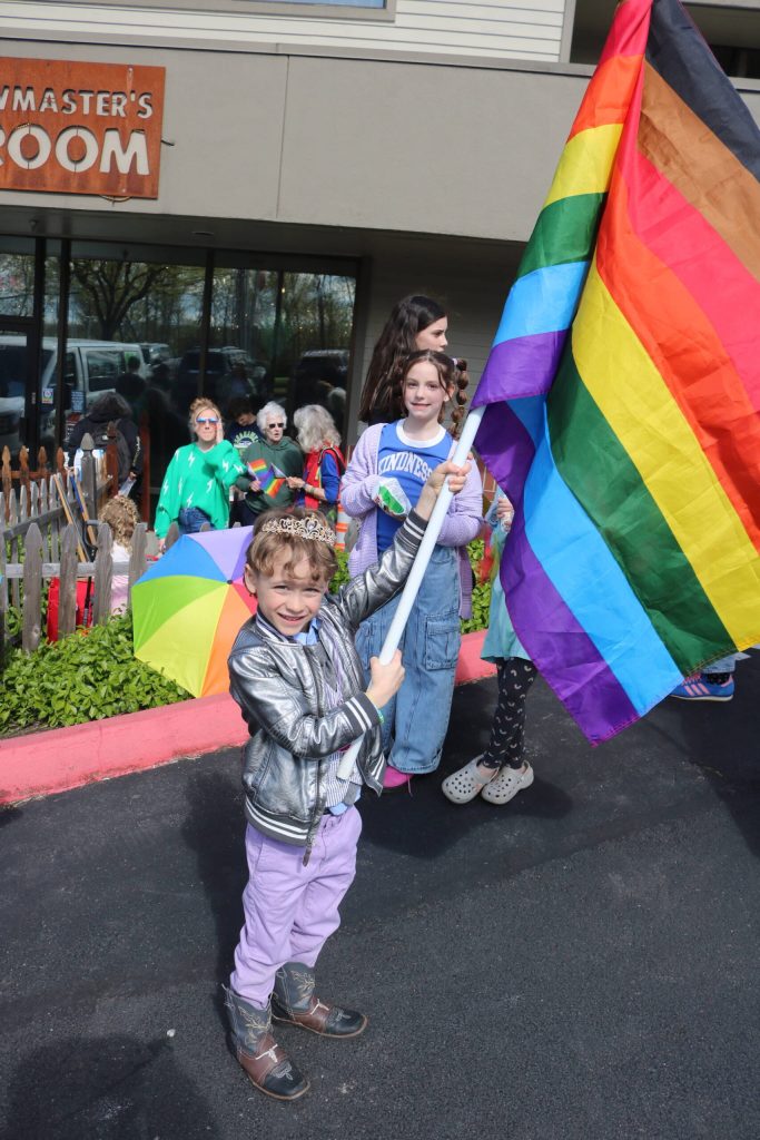 Declan Gathman, 6, waves a pride flag outside the kid-friendly and dog-friendly taproom. Photo by Bailey Jo Josie/Sound Publishing.