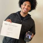 John Sanchez displays his award and winning photo. COURTESY PHOTO, Kent School District