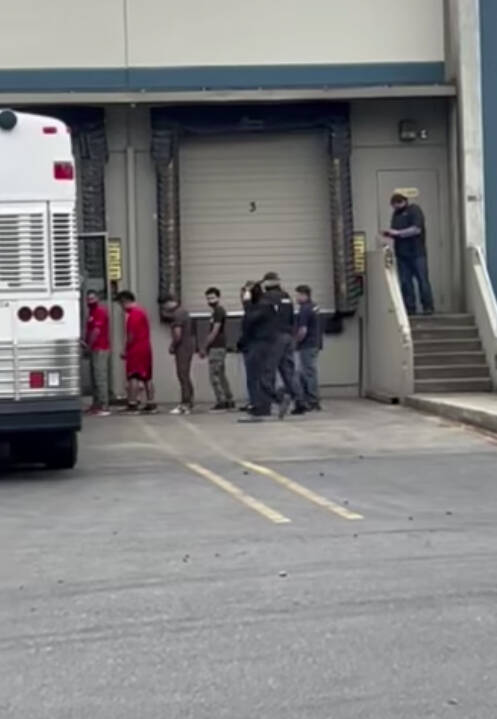 ICE and other federal agents escort people May 20 out of a Kent business. COURTESY PHOTO, Luis Cortes-Romero