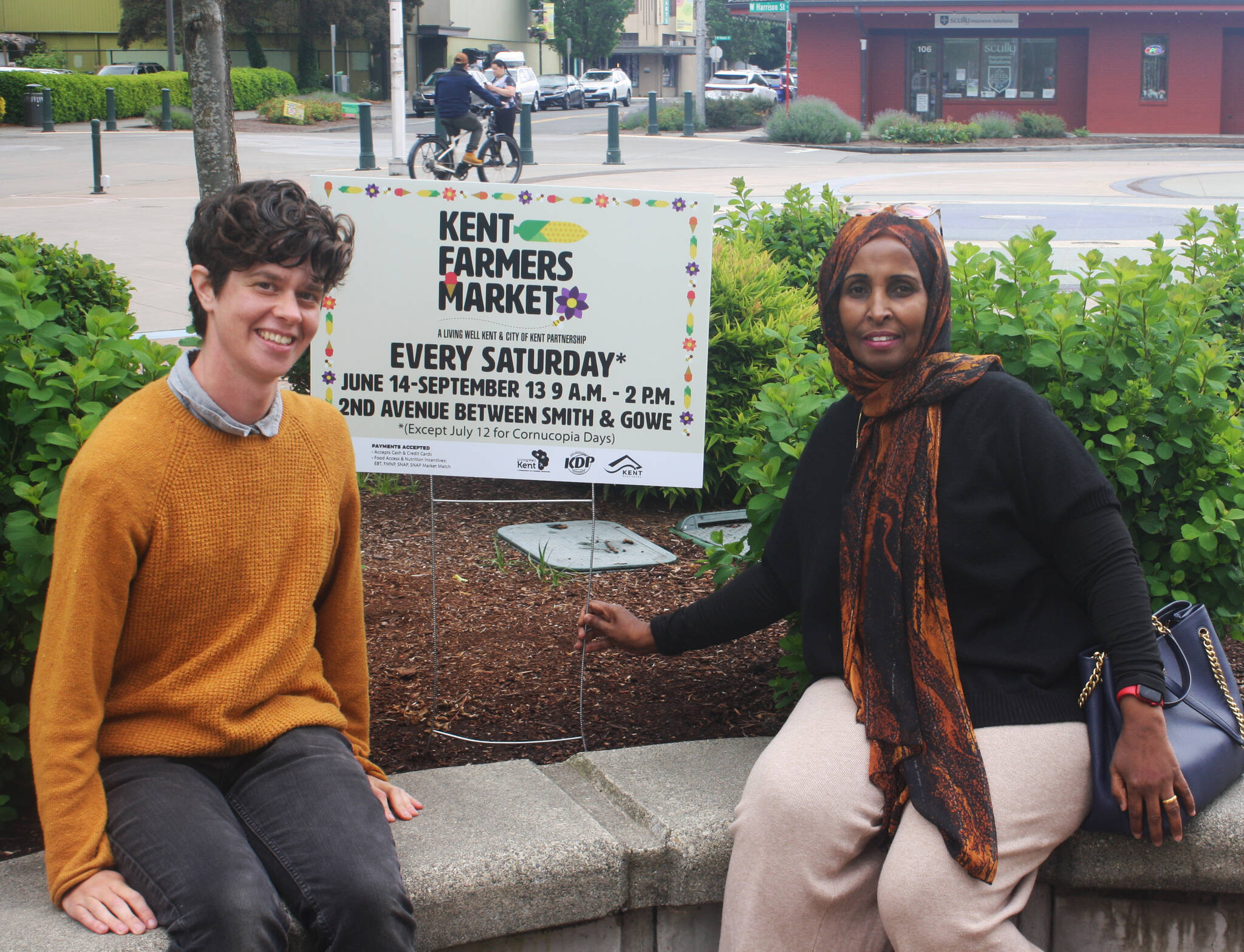 t
Izzy Ceccanti, left, Living Well Kent manager of the Kent Farmers Market, and Shamso Issak, executive director of Living Well Kent, seek to make the market a destination. STEVE HUNTER, Kent Reporter