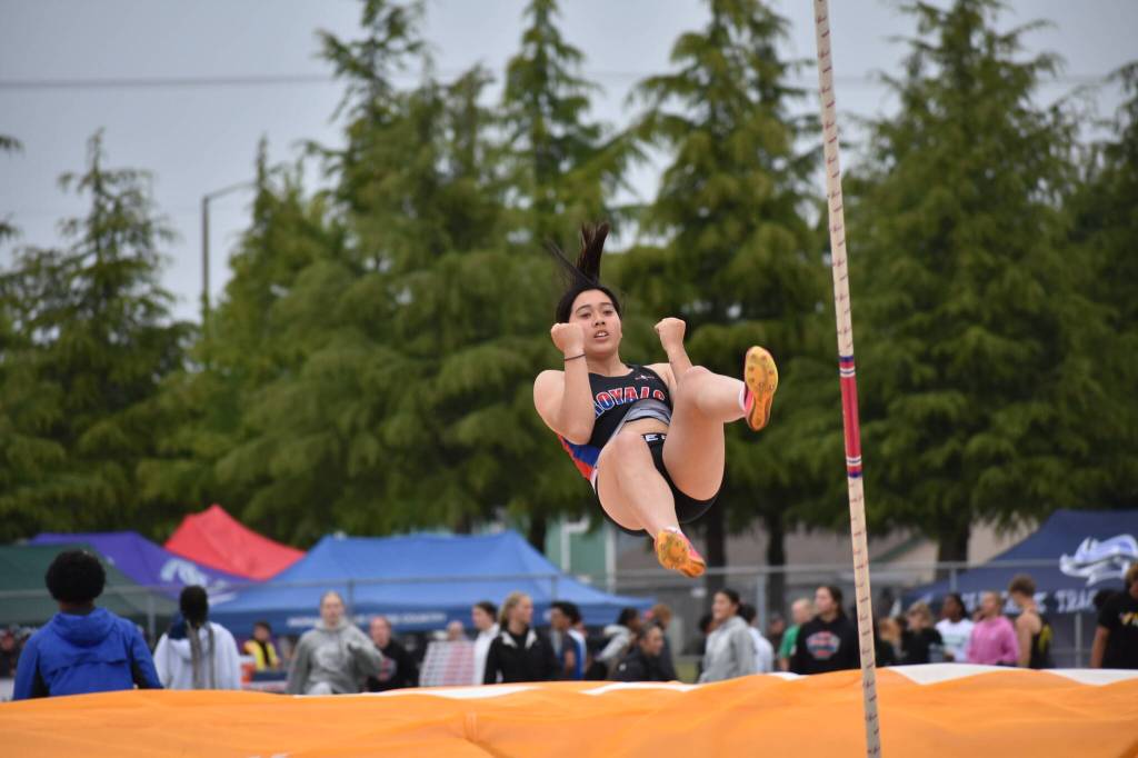 Candice Le celebrates making it over the bar in the Pole Vault for Kent-Meridian. Ben Ray / The Reporter