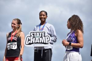 Marcella Jones gives a smile a top the podium. Ben Ray / The Reporter