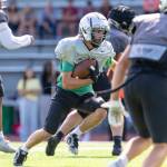 Kentwood player runs with the ball against Auburn Mountainview. Photo provided by Robby Mullikin.