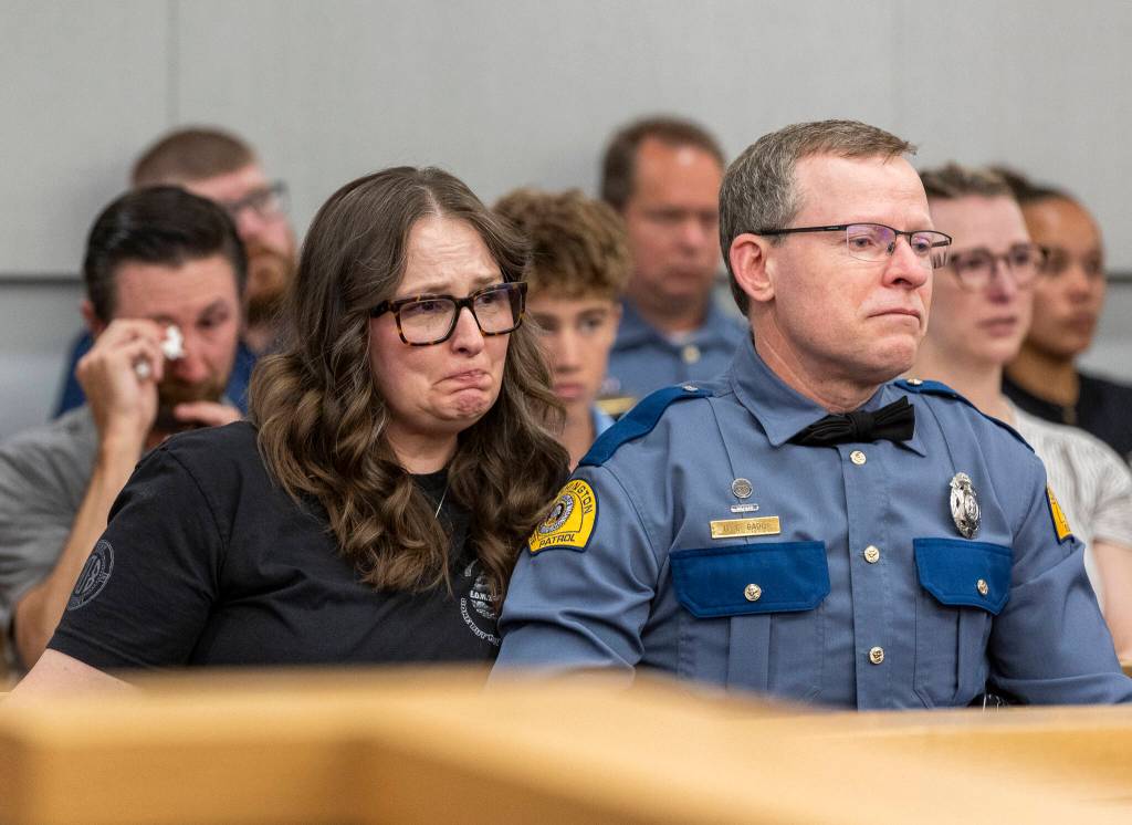 Washington State Patrol Trooper Christopher Gadds parents Gillian Gadd and WSP Trooper David Gadd listen as the judge delivers her sentence for Raul Benitez Santana during his hearing at the Snohomish County Courthouse on Wednesday, July 2, 2025 in Everett, Washington. (Olivia Vanni / The Herald)