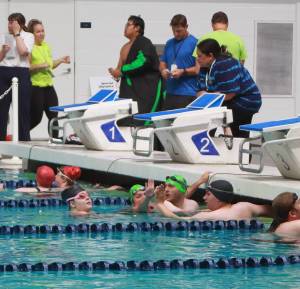 Special Olympics athletes high-five each other after a swim relay race at the 2025 Spring Games at the Weyerhaeuser King County Aquatic Center in Federal Way. The aquatic center is among recreational facilities and parks across the region that would receive upgrades with the passage of the King County Parks Levy on the Aug. 5 primary ballot. (File photo)